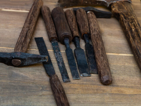 A set of woodworking tools including a hammer, chisel, and saw
