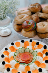 Colorful display of bagels and a decorative vegetable platter at a brunch gathering in a cozy cafe setting