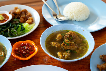 Balinese lunch with rice, fried pork and soup, Bali, Denpasar