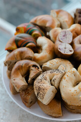 Freshly baked bagels arranged on a platter with a variety of flavors and colors