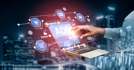 A person interacts with a laptop showcasing advertising icons and analytics in a modern urban setting, symbolizing digital marketing and creative strategies. Tessel