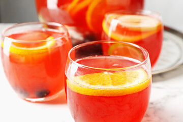 Fruity punch on white marble table, closeup. Refreshing drink