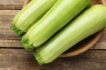 Fresh ripe zucchinis on wooden table, top view