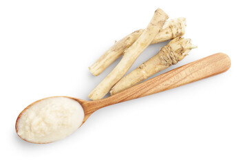 Tasty horseradish sauce in spoon and roots isolated on white, top view