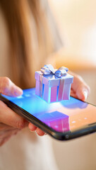 a person's hand holding a modern smartphone, with a glowing holographic gift box floating above the screen