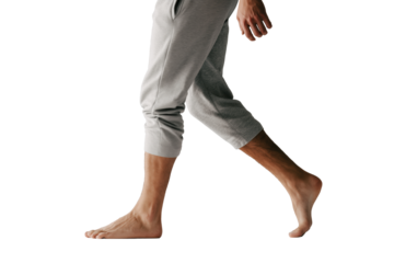 Barefoot man walking in casual homewear sweatpants and comfortable loungewear outfit side view PNG with a transparent background