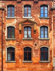 Fototapeta premium Facade of a weathered brick building