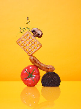 A balanced pile of breakfast food items graphic colourful

