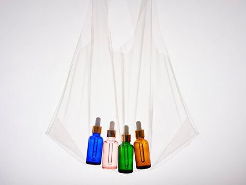 Four coloured dropper bottles in a clear plastic bag