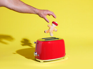 Piece of toast in shape of person popping out of red toaster