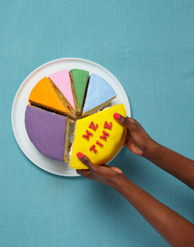 Pie chart 'ME TIME' lettering cake with hands on blue background