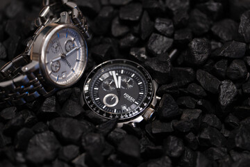 Bucharest Romania 16 September 2025.Elegant Fossil wristwatches for men and women displayed together on a black stone background. Stylish product photography showcasing luxury timepieces.