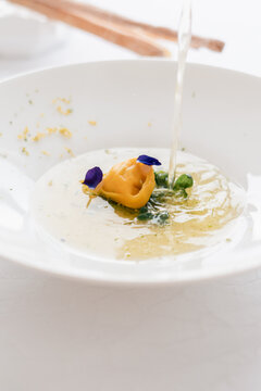 Elegant Serving of Consomme Soup With Vibrant Garnish