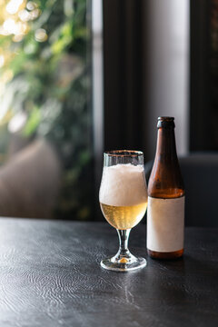Refreshing Beer Served in a Glass With a Bottle on the Table