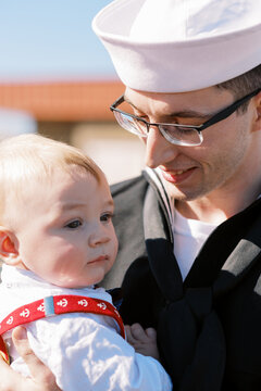 happy smiling us navy sailor at homecoming from deployment