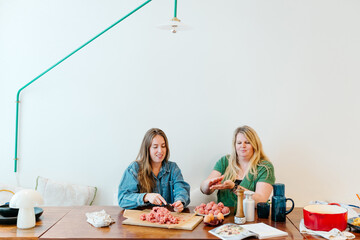 Women cooking at home with copy space