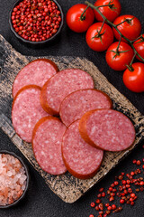 Sliced salami sausage, smoked dry meat as food background. Sliced salami