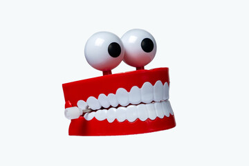 Chattering teeth toy with googly eyes on white background
