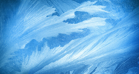 Frosty winter background with icy pattern and snow texture on frozen glass