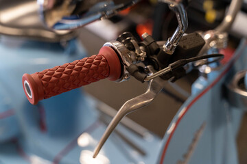 Red handle grip and brake lever of vintage scooter