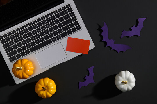 Halloween Desk with Laptop, Pumpkins, and Bats Decorations