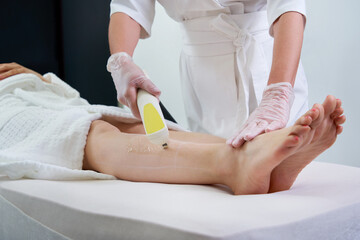 Woman in professional beauty clinic during laser hair removal