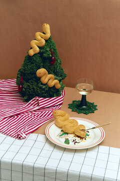 Naklejki Christmas tree made of kale with dessert and a glass of wine