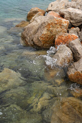 Large stones in the Adriatic sea with turquoise water