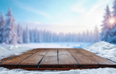 Snowy mountain landscape in the heart of winter, with tree-covered slopes and frosty pine forests under a bright winter sky. Empty wooden surface snow-covered space perfect for product placement.