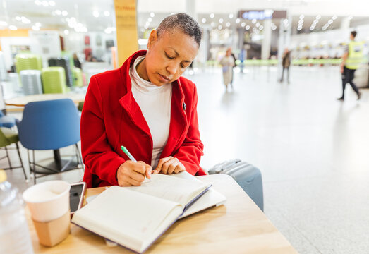 a mature woman writing in her diary