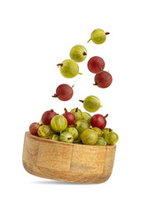 Gooseberry berries in a wooden plate isolated on a white background