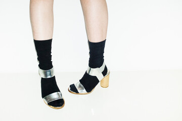 Person with shiny metallic fashion style silver high heels with flash