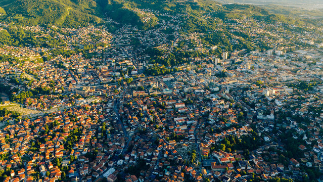 Sarajevo aerial view at sunset with red rooftops and green hills