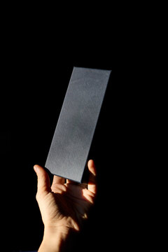 Hand holing a black box