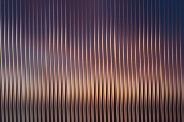 An abstract background featuring a series of vertical lines with a gradient of purple and orange hues. The lines create a textured and patterned effect.