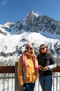 Two Women Posing in Front of Aiguille du Dru in the French Alps