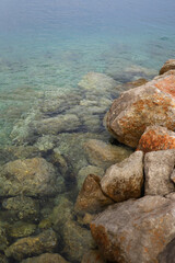 Large stones in the Adriatic sea with turquoise water