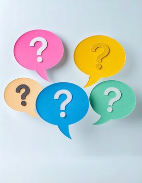Colorful question mark speech bubbles arranged on a light background