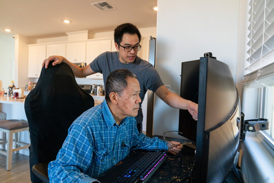 son helping dad computer 