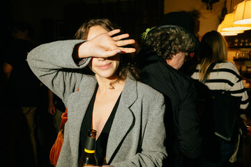 Woman Covering Face at Social Gathering