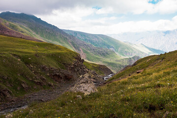 Panorama of caucasian Kazbegi mountains in Georgia. drama sky, mountain peaks, high resolution photo.