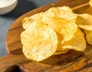 Stacked potato chips on a wooden board
