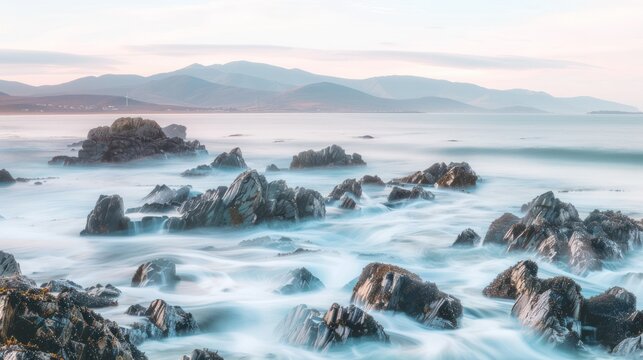 Serene Rocky Coastline with Ocean Waves and Mountain Background at Dawn - Powered by Adobe