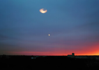 Surreal evening sky with moonlight and abstract reflection