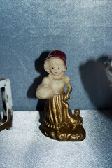 Ceramic figurine of a snowman with a red cap