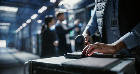 Technician scan HDD in data center.