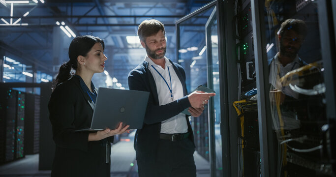 Data center technicians inspects server racks, checks network cables.