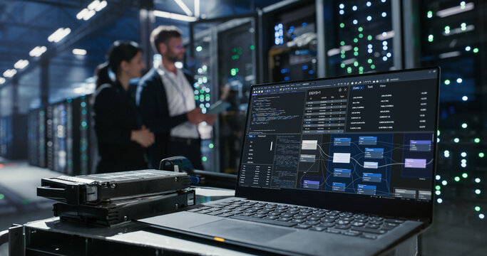 Laptop with graphs on the deks in data center