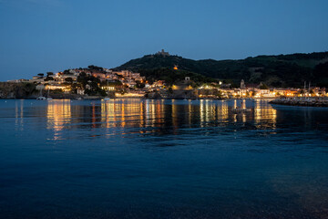 Fototapeta premium Night view on sea bay, lights and colourful houses of Collioure, Cote Vermeille, Pyrenees-Orientales, Occitania, France. Summer vacation destination