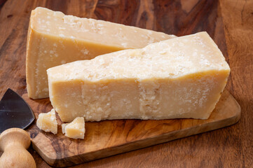 Traditional italian food, 36 months aged in caves Italian parmesan hard cheese from Parmigiano-Reggiano and grana padano from Po river valley, Italy